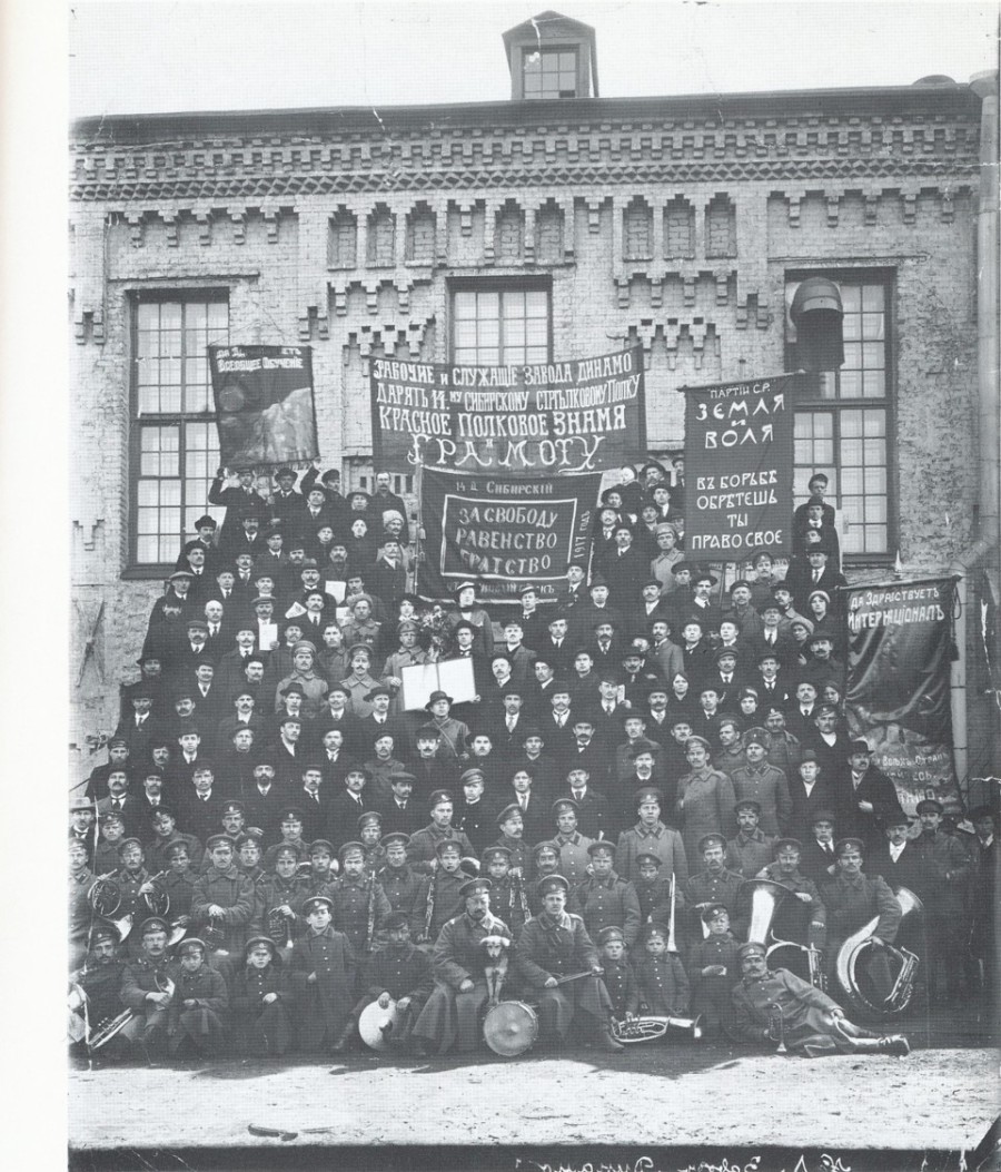 Workers at the Dinamo factory presenting banners to the 14th Siberian infantry regiment, 1917. Slogans include: “For freedom, equality and brotherhood”, “SR party. Land and freedom. You will get your rights in struggle”, “Universal education”, “Long live the international!”